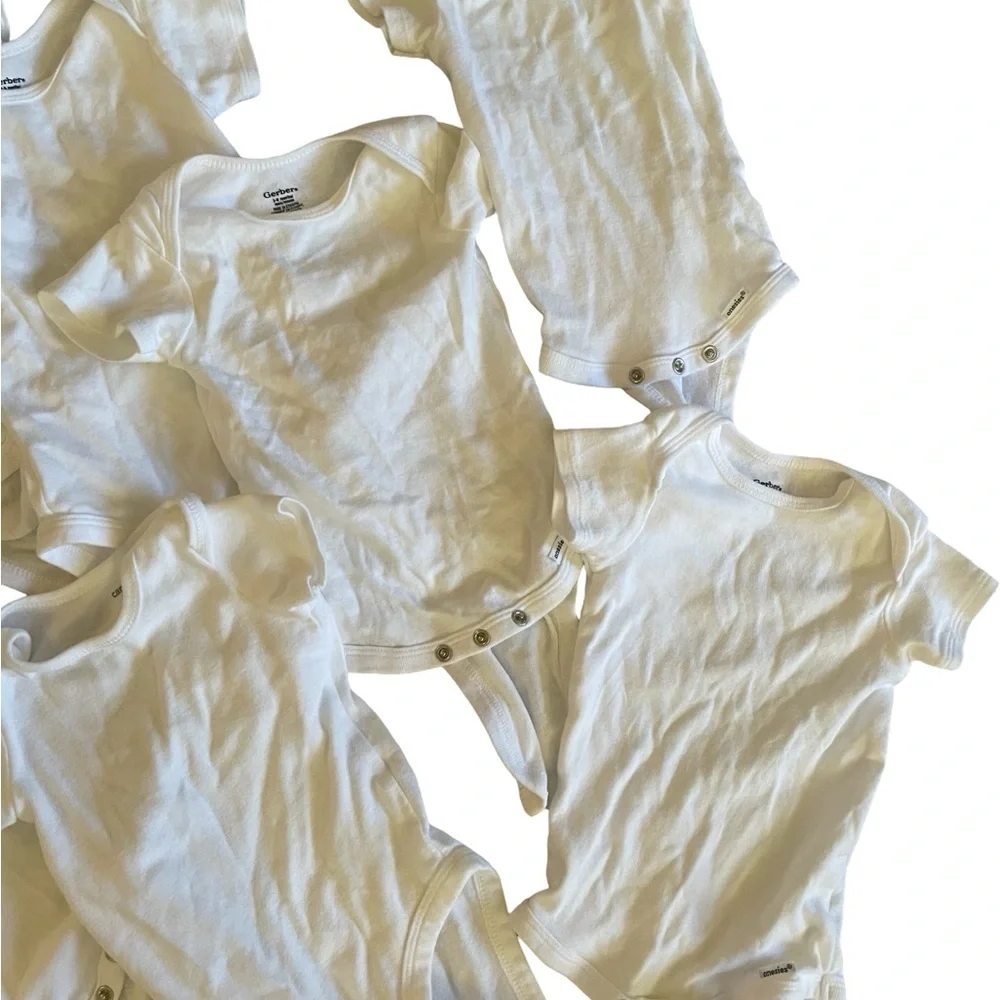 Bundle of 11 white onesies 3-6M